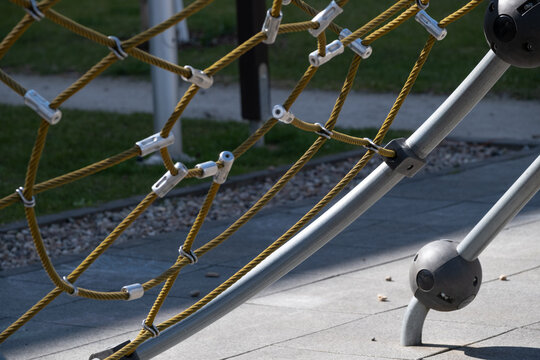 Closeup of rope climbing net on modern playground structure