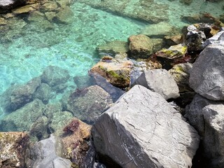 Turquoise Waters Over Rocky Shoreline