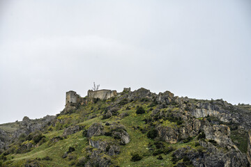 Fototapeta premium Ruins of Gama Castle on rocky hilltop in Aguilar de Campoo, Palencia