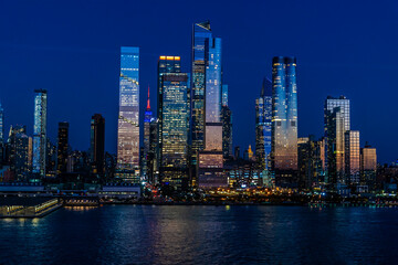 Fototapeta na wymiar A view at night from the Hudson River towards the skyline off Manhattan, New York, in the fall