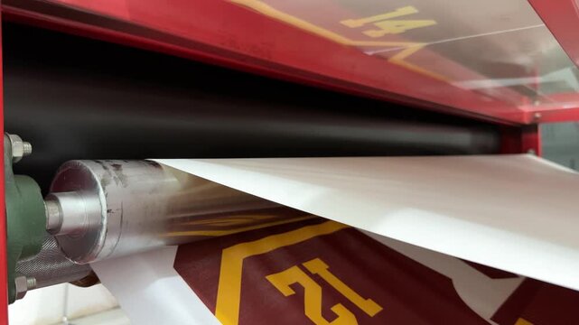 Fabric and print paper after the printing process on the roll press transfer machine