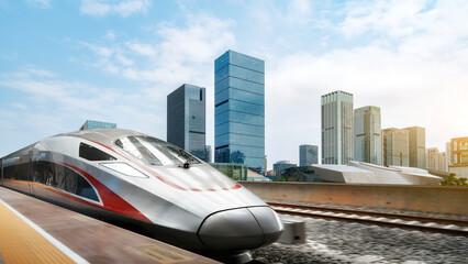 Obraz premium Modern High-Speed Train Moving Through Urban Area