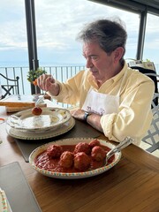 Man Enjoying Homemade Italian Meatballs with a View