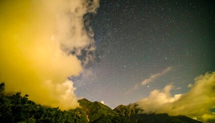 Fototapeta premium Golden Clouds Frame Starry Night Sky Above Mountain Peaks