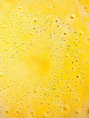 Pancake batter cooking in a hot pan creating bubbles