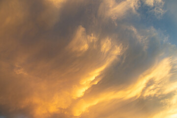 Fiery Cirrus Clouds in a Blue Sky at Sunset