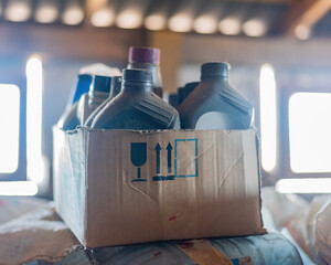 Automotive oil liquids in box, cardboard box liquids container.