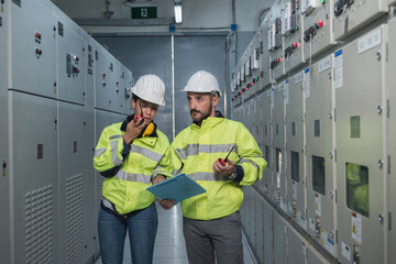 electrician working in a factory. electrician at work. electrician working in a power station. engineer working on the checking status switchgear electrical energy distribution substation.
