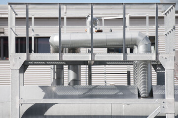The photo shows close-up of pipeline elements at an industrial plant