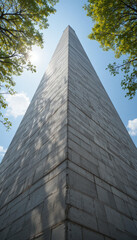 Monumental pyramid obelisk urban park architectural photography bright day low angle view historical significance