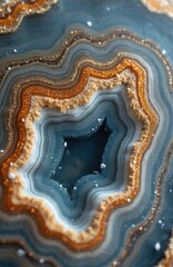Close-up abstract pattern of blue, gold agate stone with sparkling glitter. Natural mineral with concentric layers, rough texture detail. Elegant, sophisticated design for luxury decor, interior