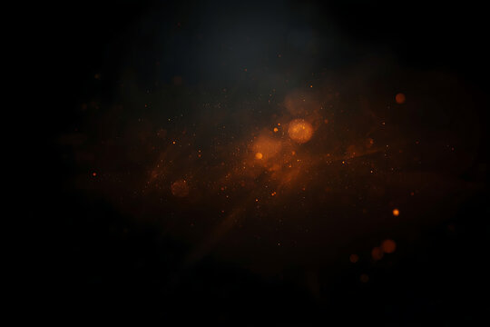 The image features a dark abstract background with deep black tones, soft orange blurry light flares, scattered light particles, and subtle lens scratches, creating a moody cinematic texture.