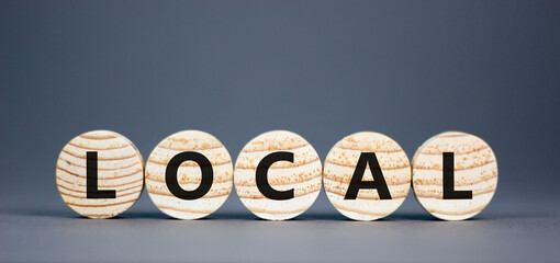 Local symbol. Concept word Local on beautiful wooden circles. Beautiful grey table grey background....