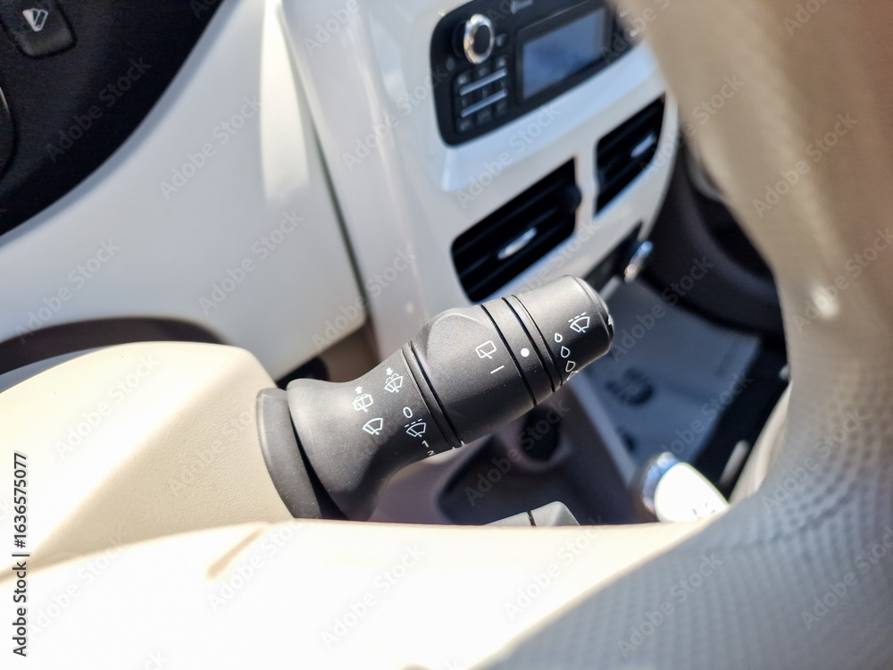 Poster detailed closeup of a vehicles turn signal lever located inside the dashboard of an automobile, show