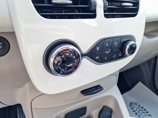 The modern car interior is equipped with a sophisticated climate control console that features...