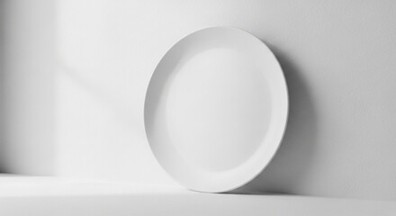 Empty white oval plate against a bright white background.