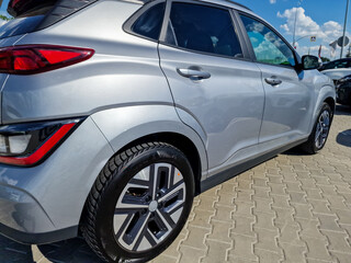 A sleek silver SUV, showcasing a contemporary design and stylish rims, is parked confidently...