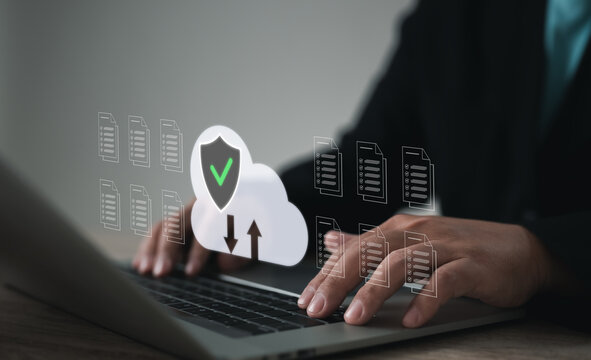 Hands typing on laptop with secure cloud storage interface, featuring upload and download icons, document management, and encryption, symbolizing safe data transfer and digital file protection.