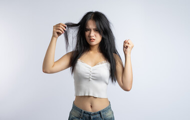 Frustrated woman displaying tangled hair against white Expressive emphasizing hair care issues