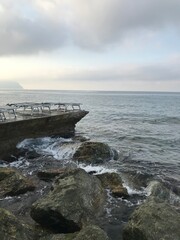 Pebbled beach with waves softly breaking in the morning light.
