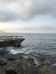 Soft clouds above the sunrise-lit Mediterranean Sea.

