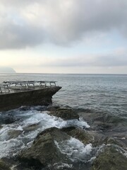 Warm golden rays shining on the tranquil Italian shore.
