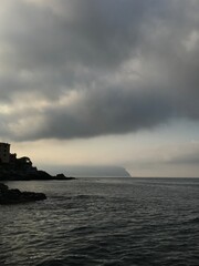 Secluded rocky beach with mountains in the background.
