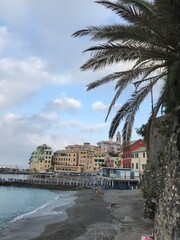 View of the coastline with rocks and distant mountains.
