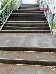 A beautifully designed staircase leads to an impressive bridge, featuring a sturdy handrail of...