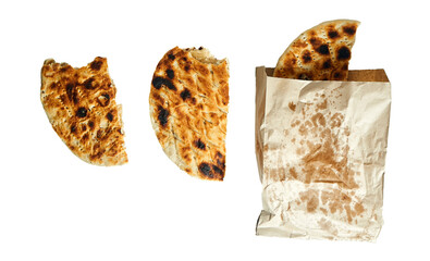 Halved flatbreads and a grease marked paper bag arranged in a clean layout, isolated on white...
