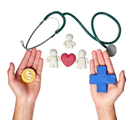 Two hands weighing a coin with dollar sign and a blue medical cross beneath a stethoscope and...