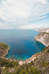 From a high vantage point, the eye drinks in the stunning vista of Zakynthos. Turquoise waters embrace rugged, verdant cliffs in this alluring Greek island getaway