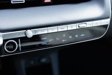 Car air conditioning button inside a car. Modern car climate control panel for driver and passenger...