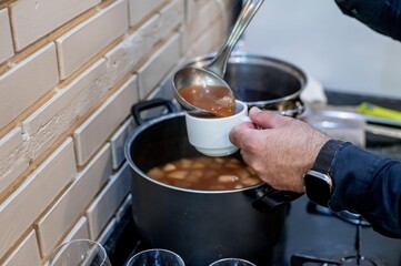 Male hands serving cup of apple tea