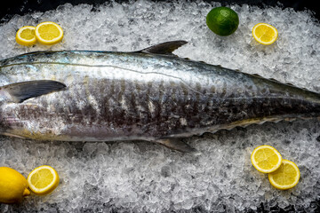 Tuna fish carcass on ice with lemons macro photo