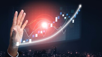 A businessman interacts with virtual financial data displays featuring graphs and charts. The image highlights modern technology in a professional office setting at night. Copula