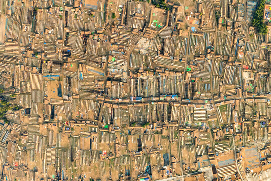 Aerial view of tightly packed structures and narrow pathways create a textured mosaic under the warm sun, Sundarban, Khulna Division, Bangladesh.