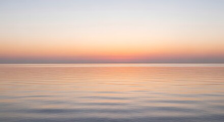 Calm sea at sunset with a clear horizon and peaceful scenery view