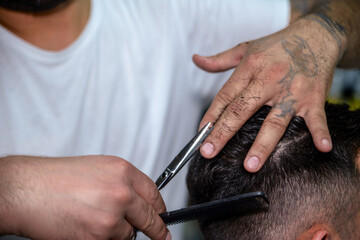 The barber is shaving in the hairdresser's shop
