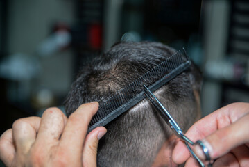 The barber is shaving in the hairdresser's shop
