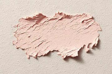 Beauty product smear revealing smooth texture, soft brush markings against pale surface