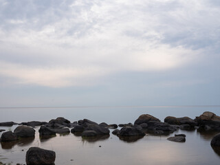 sea with stones on a cloudy summer day