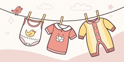 Adorable baby clothes hanging on a clothesline perfect for nurseries and baby showers designs