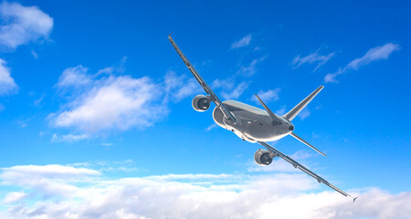White passenger airplane flying in cloudy blue sky