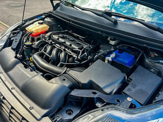 A CloseUp and Detailed View of a Modern Car Engine Bay, Showcasing the Intricate Components and Innovative Engine Design That Power Todays Advanced Vehicles and Boost Performance Efficiency