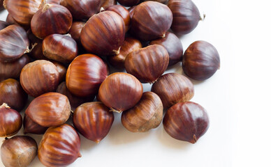 New harvest, ripe shelled chestnuts, designed on a white surface