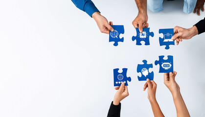 Diverse hands collaboratively assemble blue puzzle pieces with AI icons, symbolizing teamwork,...