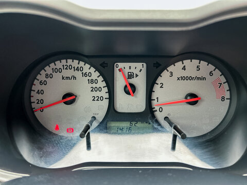 The cars dashboard instrument cluster is efficiently displaying the speedometer, tachometer, and fuel gauge readings, providing critical information for vehicle operation and performance assessment