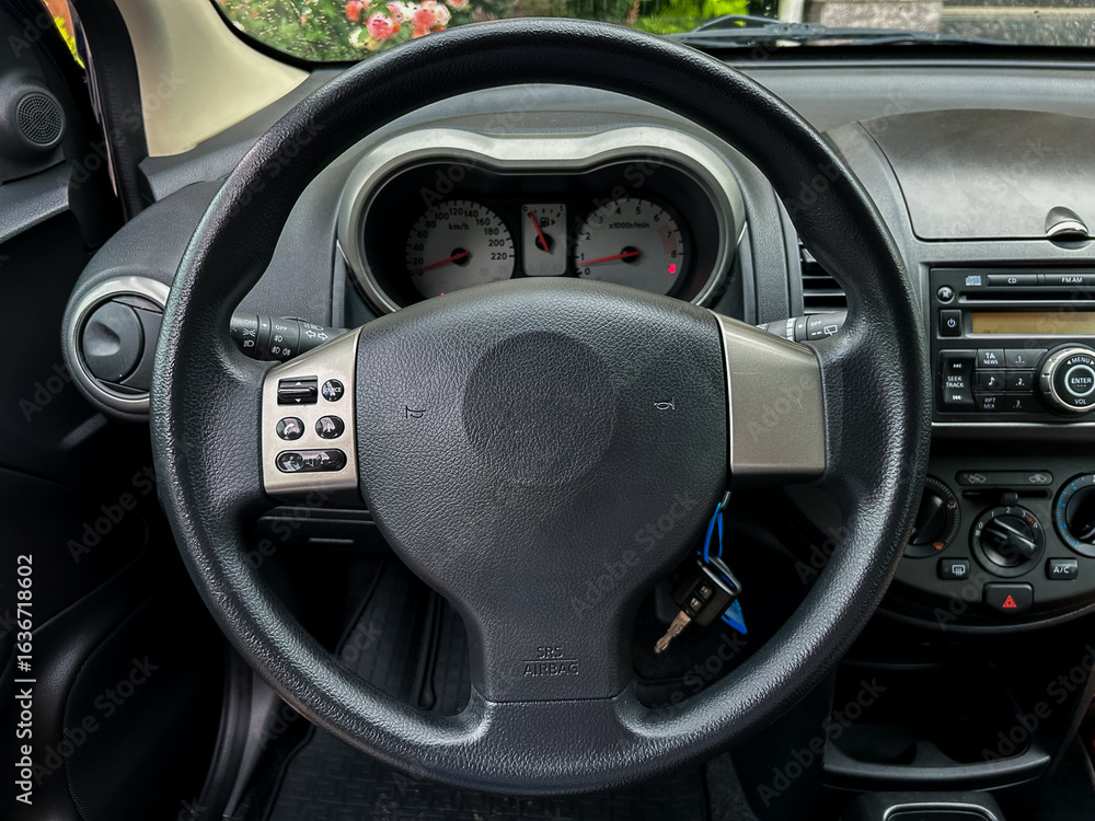 Poster the interior of a modern car includes a welldesigned steering wheel alongside an array of dashboard 