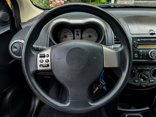 The interior of a modern car includes a welldesigned steering wheel alongside an array of dashboard...